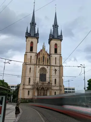 an old church with two towers on a street at Letenský pokoj Milada E2 in Prague
