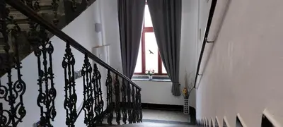 a hallway with a stairway with a window at Two-room apartment near the center F2 in Prague