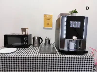 a black and white table with a coffee maker and a microwave at Two-room apartment near the center F2 in Prague