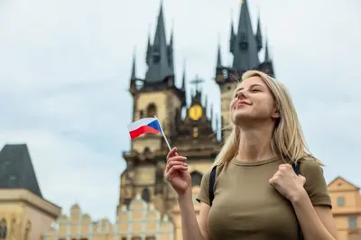 a woman holding a flag in front of a building at Sunny room in centre of Prague H1 in Prague