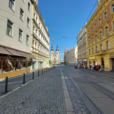 an empty street in a city with buildings at Letní pokoj na Pražské Letné H5 in Prague