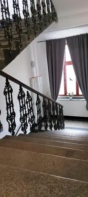 a stair case with a railing and a window at R2 Letná Rooftop Retreat Prague in Prague