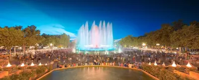 a crowd of people standing around a fountain at night at Romantický pokojíček v podkroví R5 in Prague