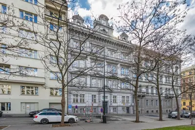 a white car parked in front of a large building at HOMELY I 50m2 central APT I ELEVATORI Park & Museum View in Prague