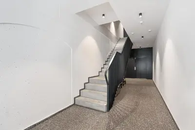 a staircase in a building with white walls at REAL Living by REFA Karlin 408 in Prague
