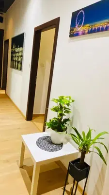a white table with two potted plants on it at Prague service Apartment - Central square location in Prague