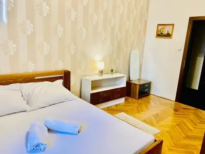 a bedroom with a white bed and a television at Prague service Apartment - Central square location in Prague