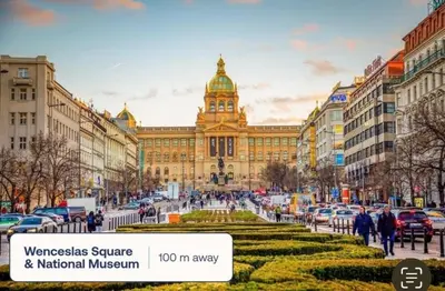 a large building with a clock tower in a city at True Relax Apartman 2 bedrooms Wenceslas square in Prague