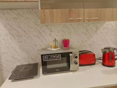a microwave sitting on a kitchen counter with a laptop at Just 3 min Walk Old Town Center private room E in Prague
