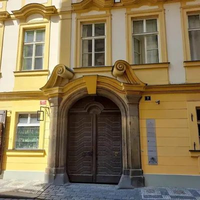 a yellow building with a large wooden door at Just 3 min Walk Old Town Center private room B in Prague