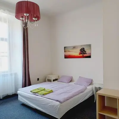 a bedroom with a bed with yellow towels on it at Just 3 min Walk Old Town Center private room C in Prague