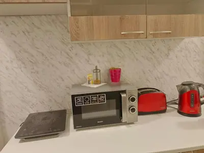 a kitchen counter with a microwave and a laptop at Just 3 min Walk Old Town Center private room C in Prague