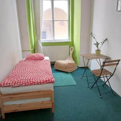 a bedroom with a bed and a table and a window at Charles bridge, Old town3 Min walk Private Room C in Prague