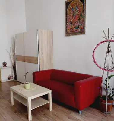 a living room with a red couch and a table at Charles bridge, Old town3 Min walk Private Room C in Prague
