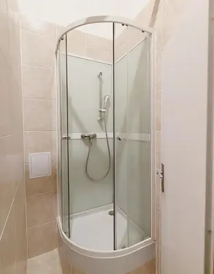 a shower with a glass door in a bathroom at Charles bridge, Old town3 Min walk Private Room E in Prague