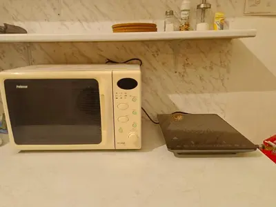 a microwave sitting on a counter next to a laptop at Charles bridge, Old town3 Min walk Private Room E in Prague