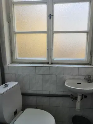a bathroom with a toilet and a sink and a window at Old Town Center Just in 3 min Walk private room A in Prague