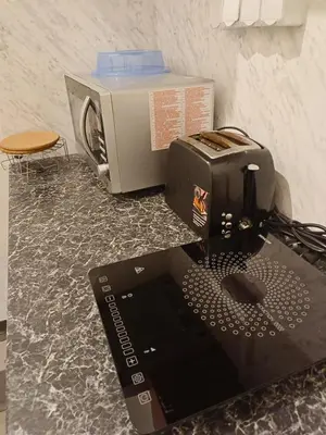 a laptop computer sitting on a counter next to a toaster at Old Town Center Just in 3 min Walk private room C in Prague