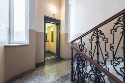 a hallway with a yellow door in a building at Duplex City-Centre Apartment with a Sunny Terrace in Prague