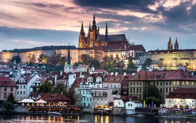 an old church with a clock tower on a street at Cozy apartments near Křižikova metro in Prague