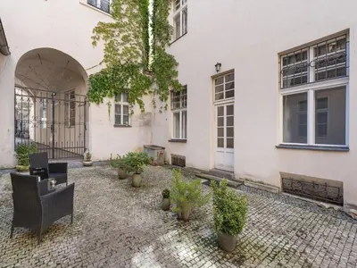 a courtyard of a building with chairs and potted plants at Apartment Old Town home-7 by Interhome in Prague