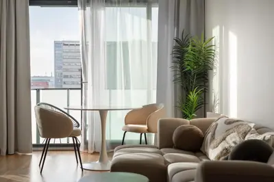a living room with a couch and chairs and a table at Cool All-in Apartment Prague in Prague