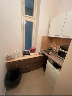 a small kitchen with a sink and a window at Štepánská 3 in Prague