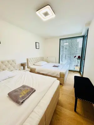 a hotel room with two beds and a window at Luxury apartments with beautiful views in Prague
