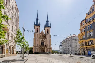 an old church with two towers on a city street at Blueground Letná furnished studio foodie area PRG-49 in Prague