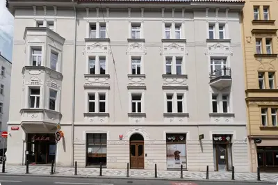 a large white building on the corner of a street at Blueground Letná furnished studio foodie area PRG-54 in Prague