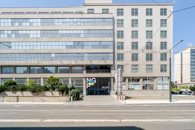 an office building with a street in front of it at Blueground Letná furnished studio foodie area PRG-54 in Prague
