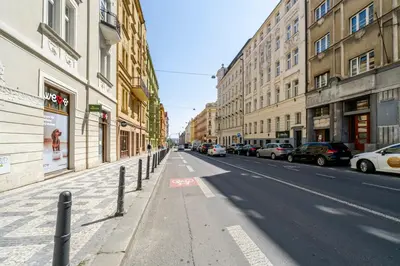 an empty city street with parked cars and buildings at Blueground Prague 7 renovated student housing PRG-59 in Prague