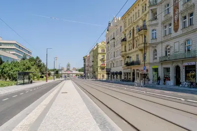 an empty street in a city with buildings at Blueground Holešovice city view nr Vltava PRG-51 in Prague