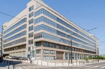 an office building with a street in front of it at Blueground Holešovice balcony nr Vltava PRG-55 in Prague