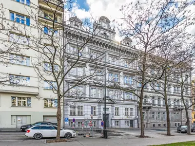 a white building with cars parked in front of it at Apartment Čelakovsky-1 by Interhome in Prague