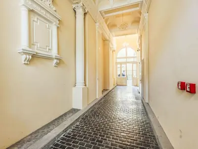 an empty hallway of a building with a brick floor at Apartment Washington-1 by Interhome in Prague