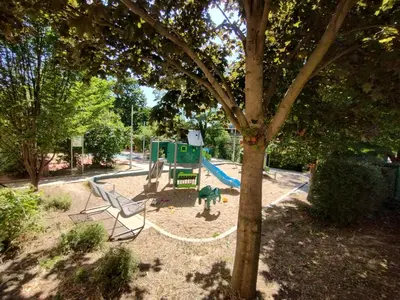 a park with a playground with a slide at Two bedroom apartment with parking in Prague