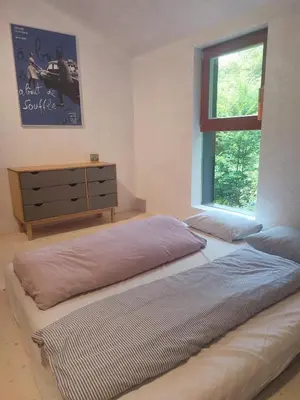 a bedroom with a bed and a dresser and a window at Romantic cottage Slapy - Renovated