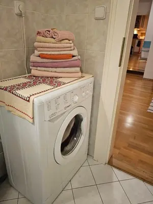 a washing machine with a stack of towels on top at 2 min Center Just In, Old Town Walk private room C in Prague