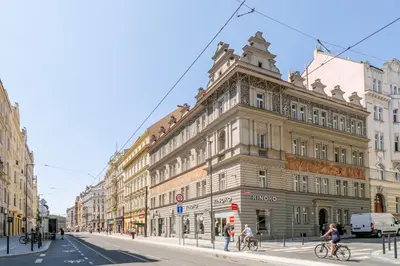 a building on a city street with people on bikes at Blueground Holešovice view nr Vltava PRG-52 in Prague
