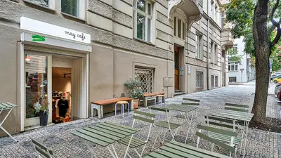 a street with chairs and tables in front of a building at Stylish Apartment near Wenceslas Square in Prague