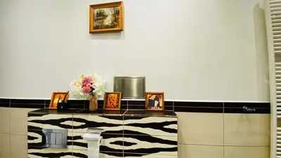 a room with a counter with pictures and flowers on it at Emperor apartment in centre in Prague