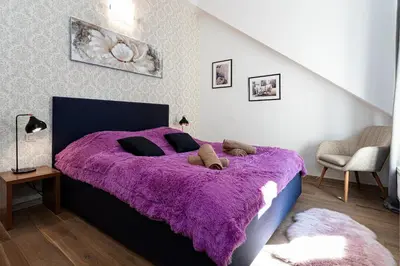 a bedroom with a purple bed with a purple blanket at Brilliant Rabbit Residence in Prague