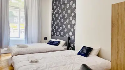 a bedroom with two beds and a wall at Private room in the Centre in Prague