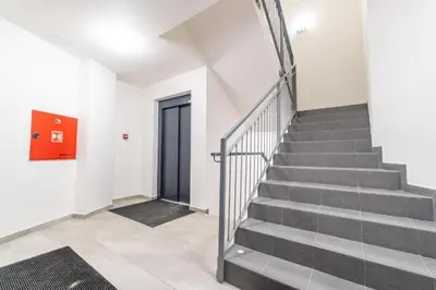 a staircase in a building with a red door at Brand new studio apartment #30 in brand new building FREE PARKING close to center in Prague