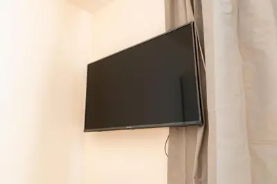 a flat screen tv hanging on a wall at Brand new studio apartment #30 in brand new building FREE PARKING close to center in Prague