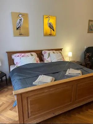 a bed in a bedroom with two birds on the wall at Štěpánská noc A in Prague