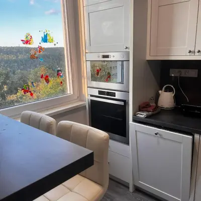 a kitchen with a stove top oven next to a window at Big apartment in quiet location close to the center -ideal for families with kids in Prague