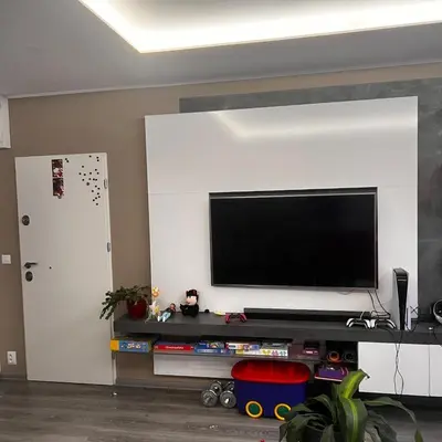 a living room with a flat screen tv on a wall at Big apartment in quiet location close to the center -ideal for families with kids in Prague