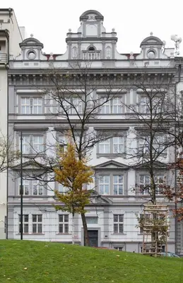 a large white building with a tree in front of it at 3 Brothers Homestay Muzeum in Prague
